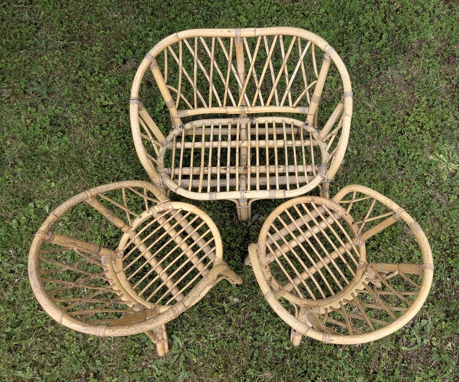 Set of children's rattan garden furniture from the 1950s and 1960s, including chairs, table, and bench.