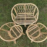 Set of children's rattan garden furniture from the 1950s and 1960s, including chairs, table, and bench.