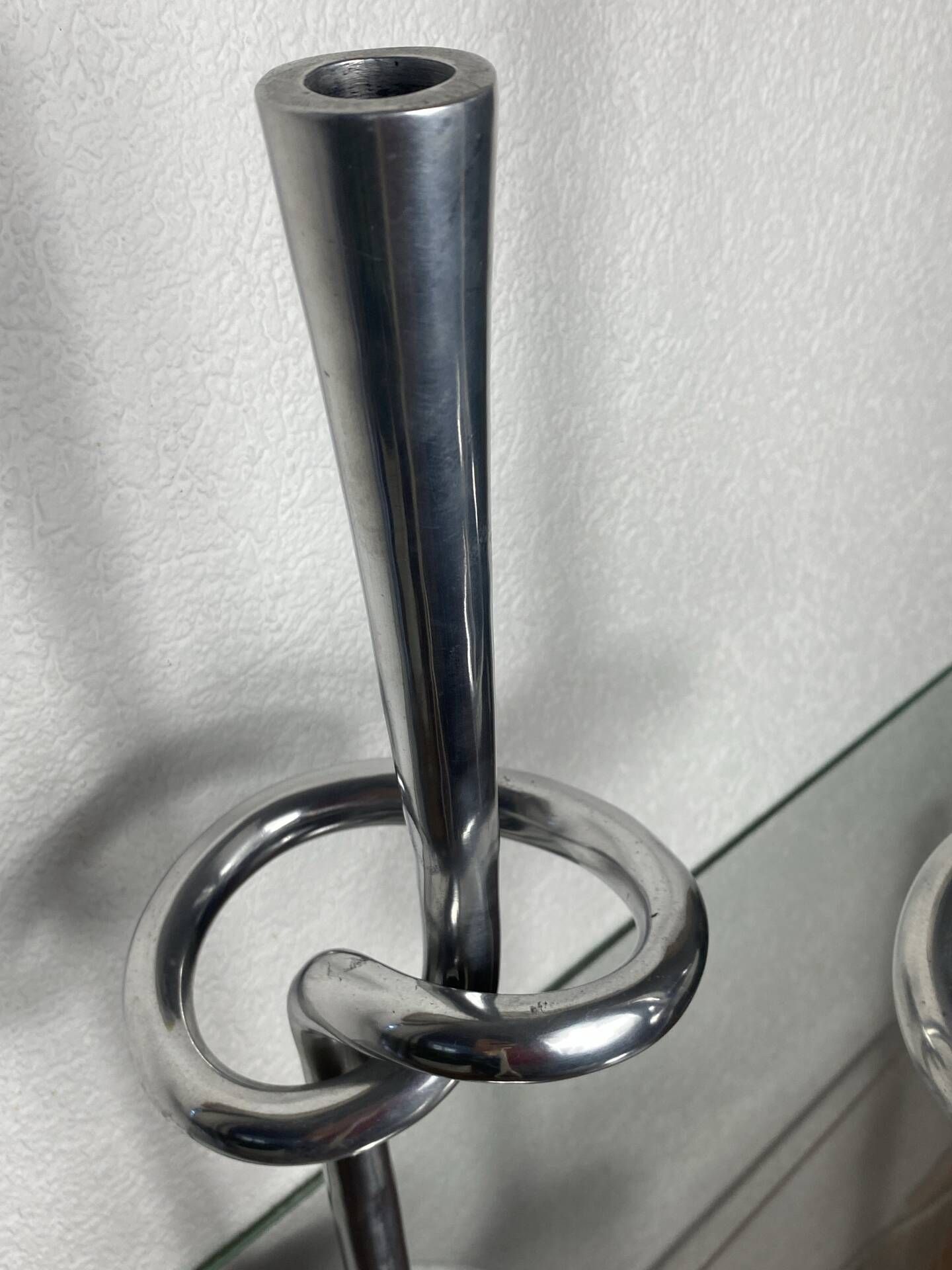 Pair of large aluminium bow candlesticks, Italy, 1970.