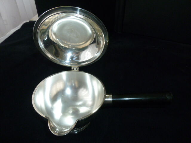 Covered saucepan with silver metal tail