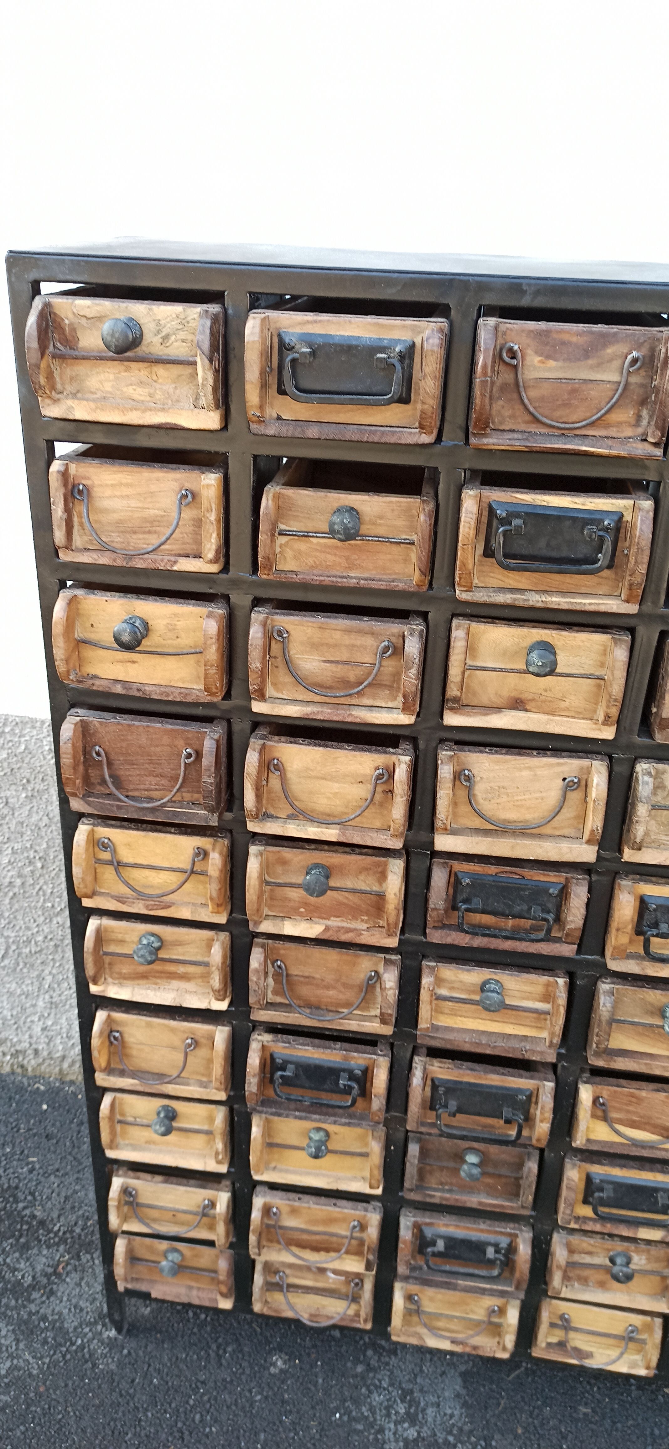 Black metal storage cabinet with 60 wooden drawers