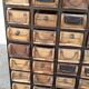 Black metal storage cabinet with 60 wooden drawers