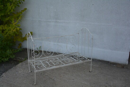Old white wrought iron child bed
