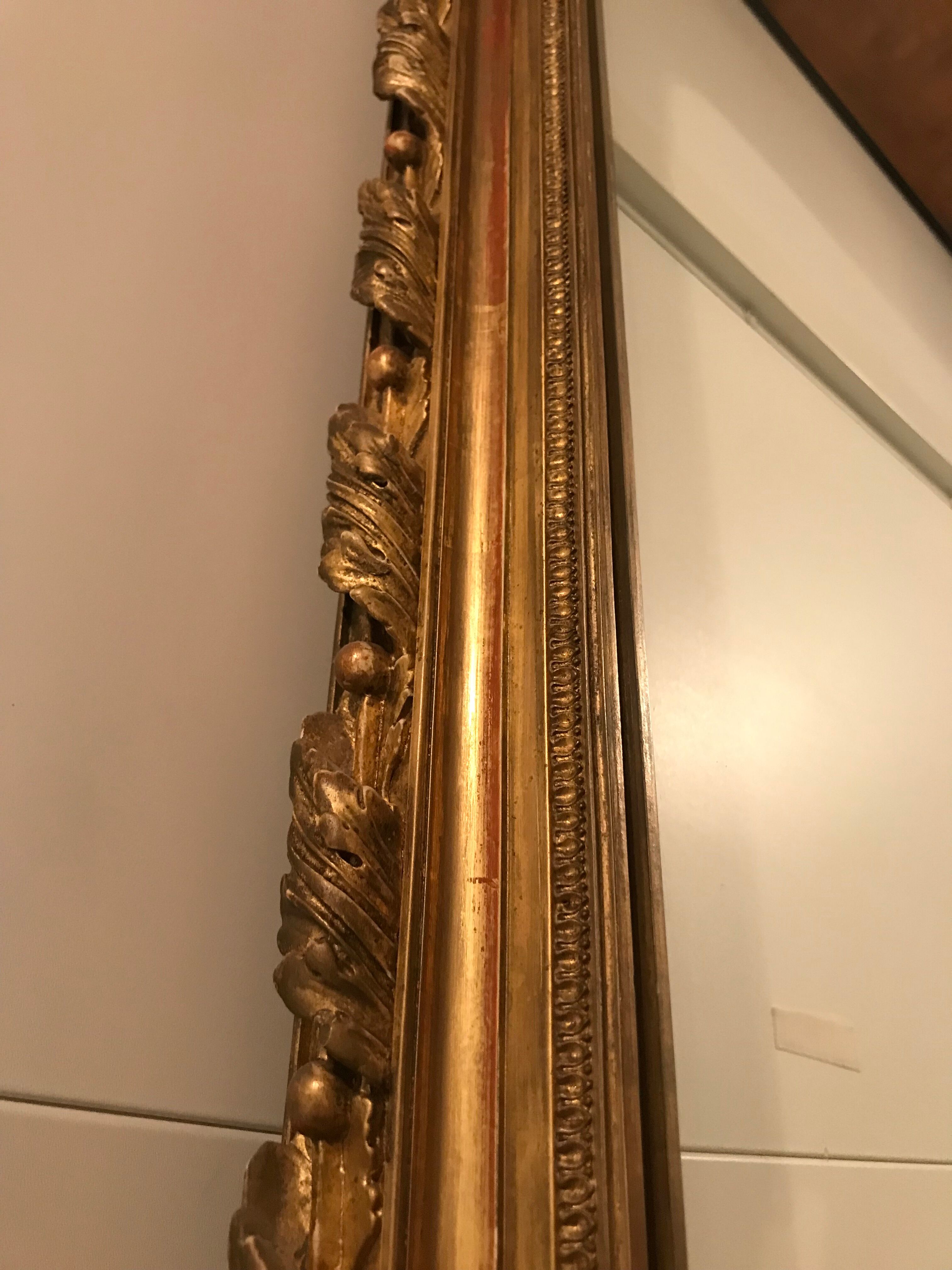 Large antique mirror with flagship shell in wood and gilded stucco
