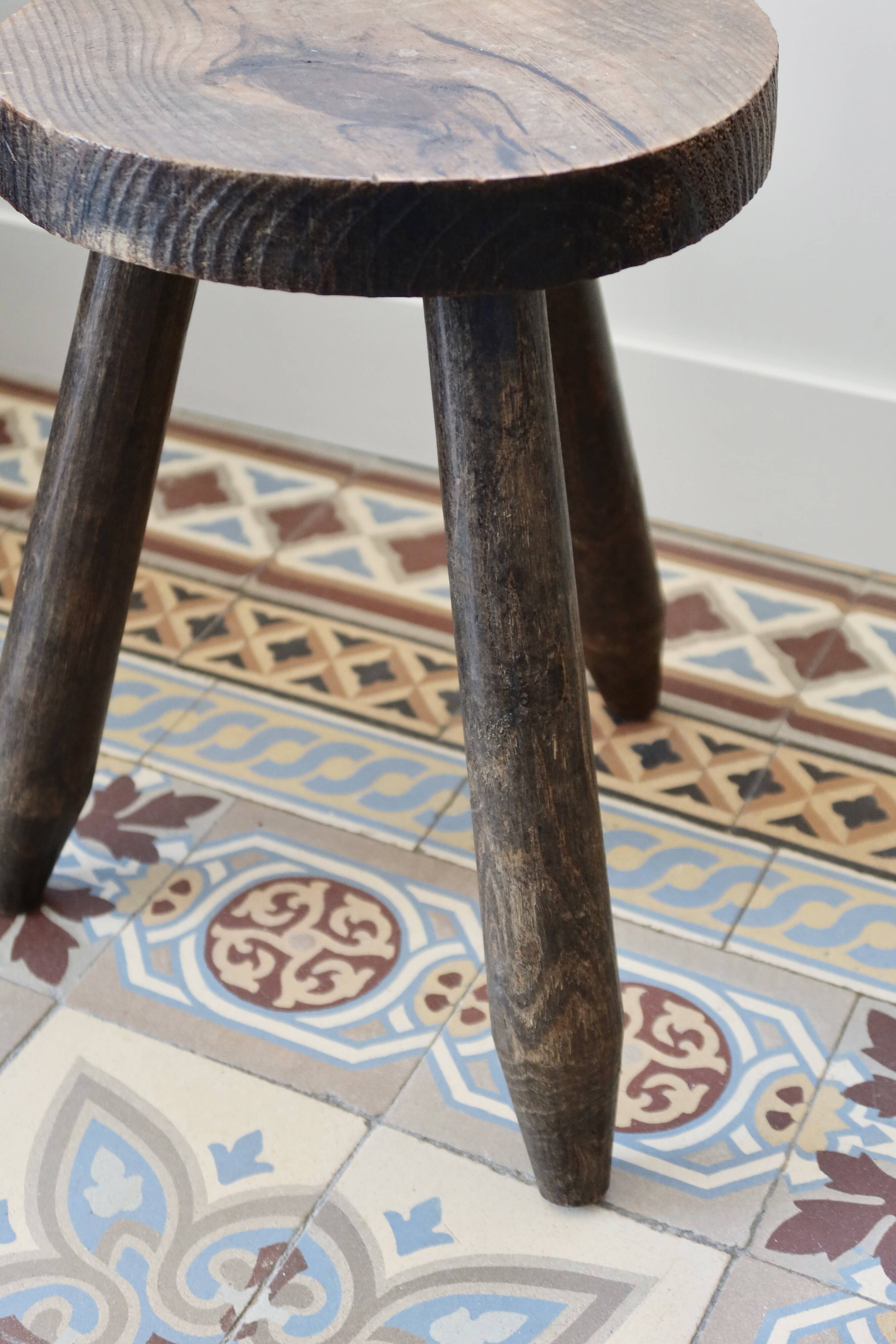 Old dark wood tripod stool