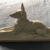 Vintage ceramic lying dog on base