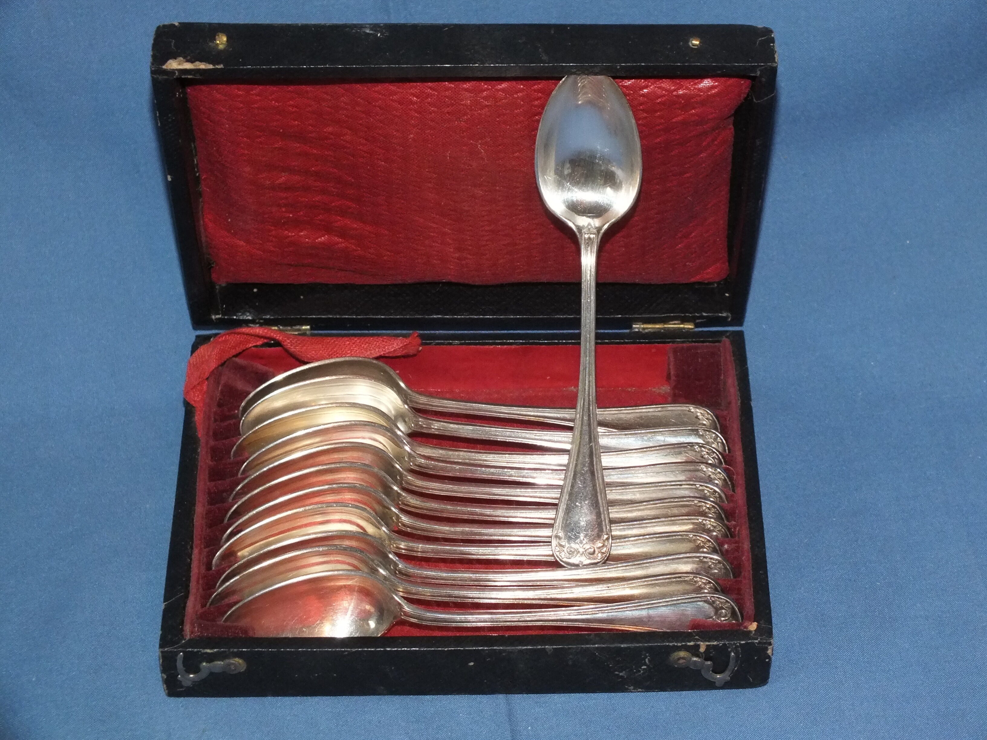 Old box of 12 small white metal spoons