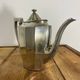 Art Deco silver-plated teapot with faceted decoration.