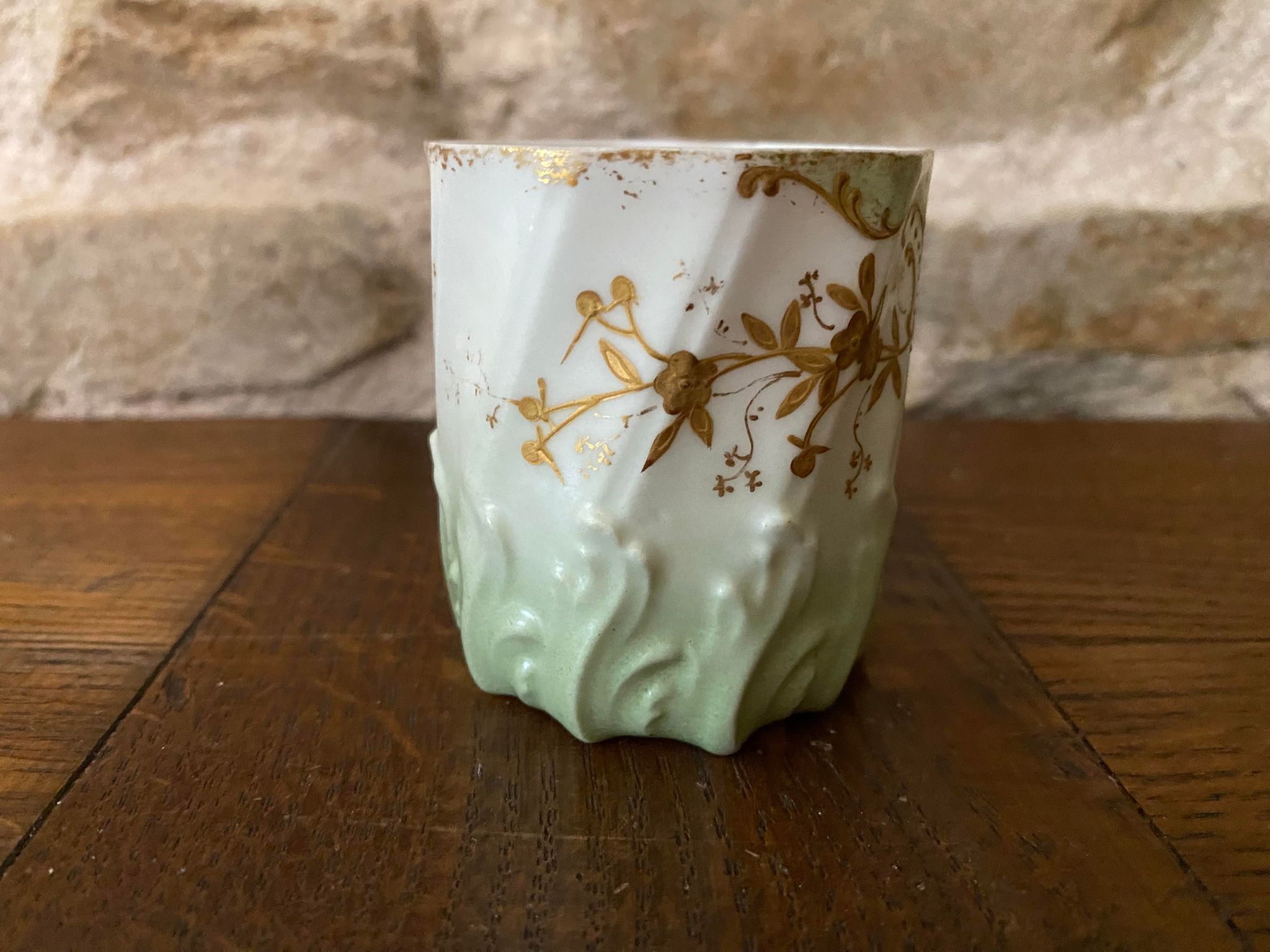 Extra fine porcelain cup pale green decorations and gilding