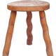 Tripod stool of folk art in light wood and wavy feet