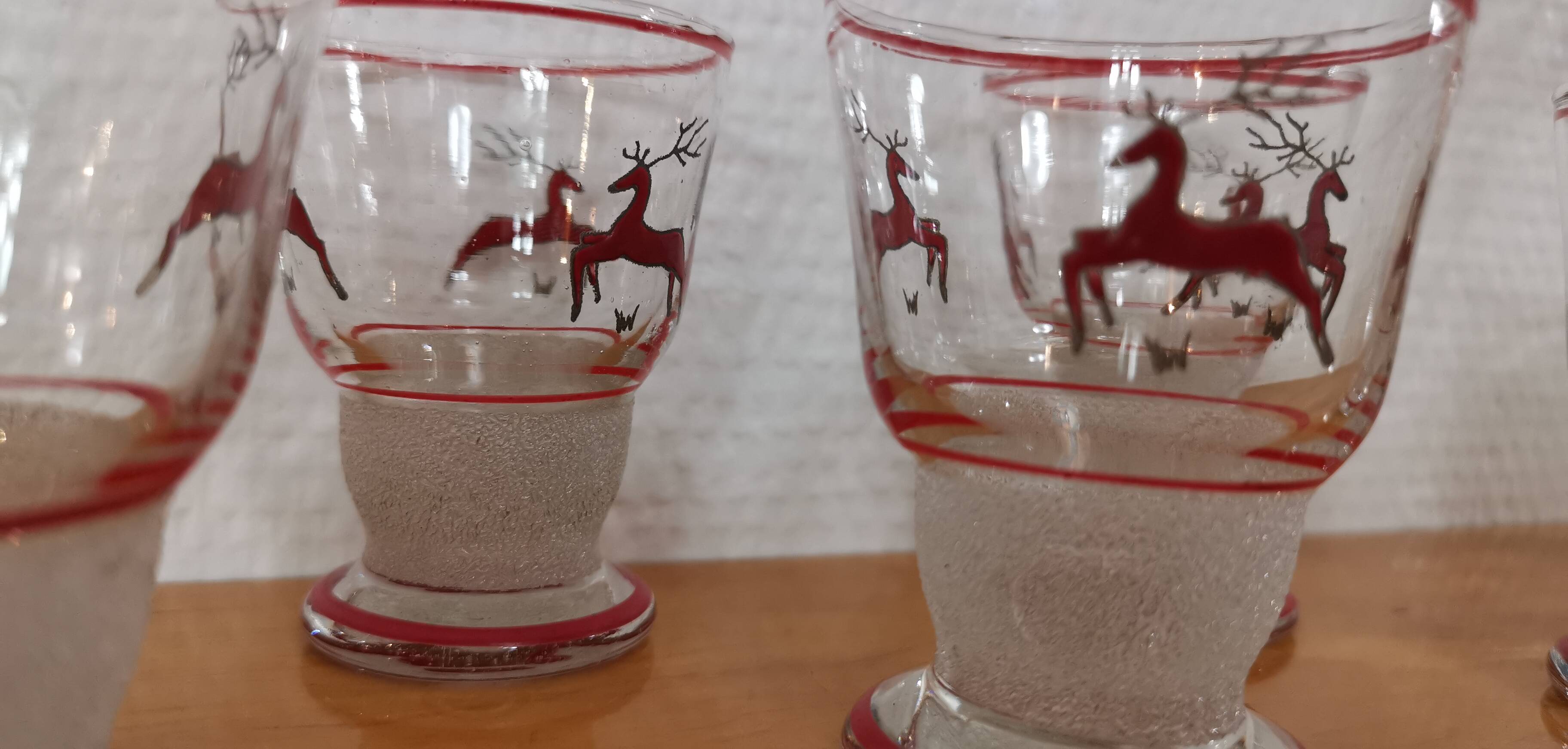 Glasses and carafe decorated with red Christmas reindeer and white granita 60's