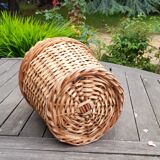 Old demijohn with handle covered with wicker
