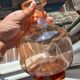 Vintage glass carafe in pink-orange, retro-chic style.