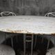 Antique painted wrought iron garden furniture, round table and four chairs.