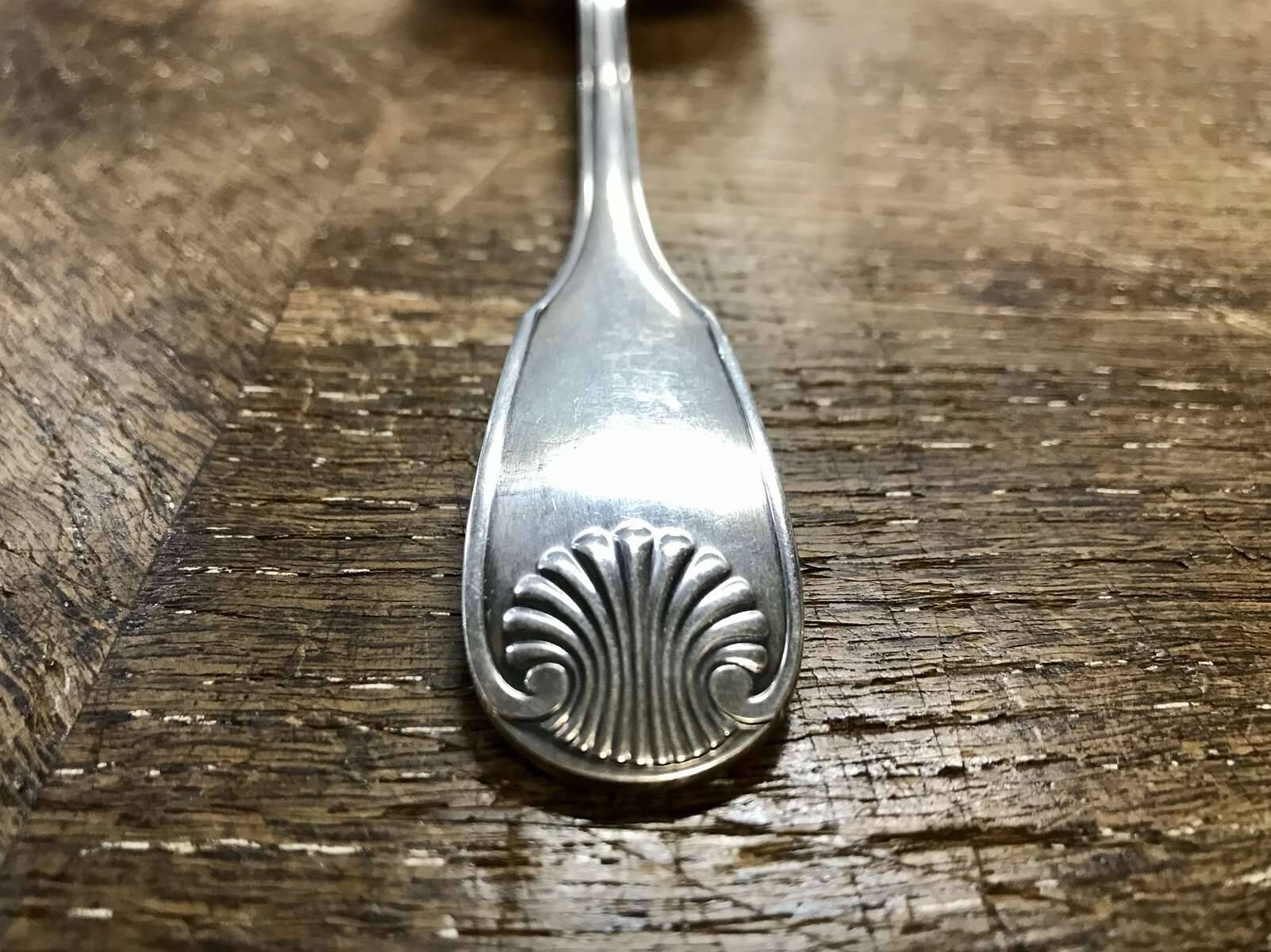 Small silver metal ladle from the Christofle brand, shell model