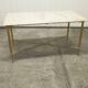 Marble coffee table with brass legs, height 46 cm.
