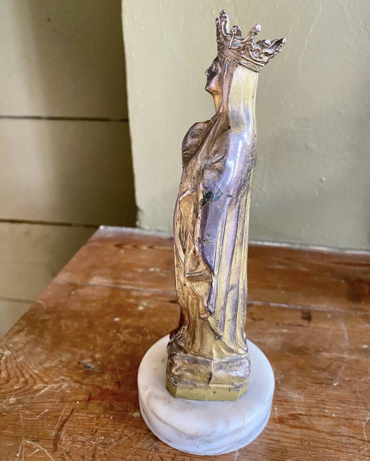 Virgin Mary crowned in metal and brass