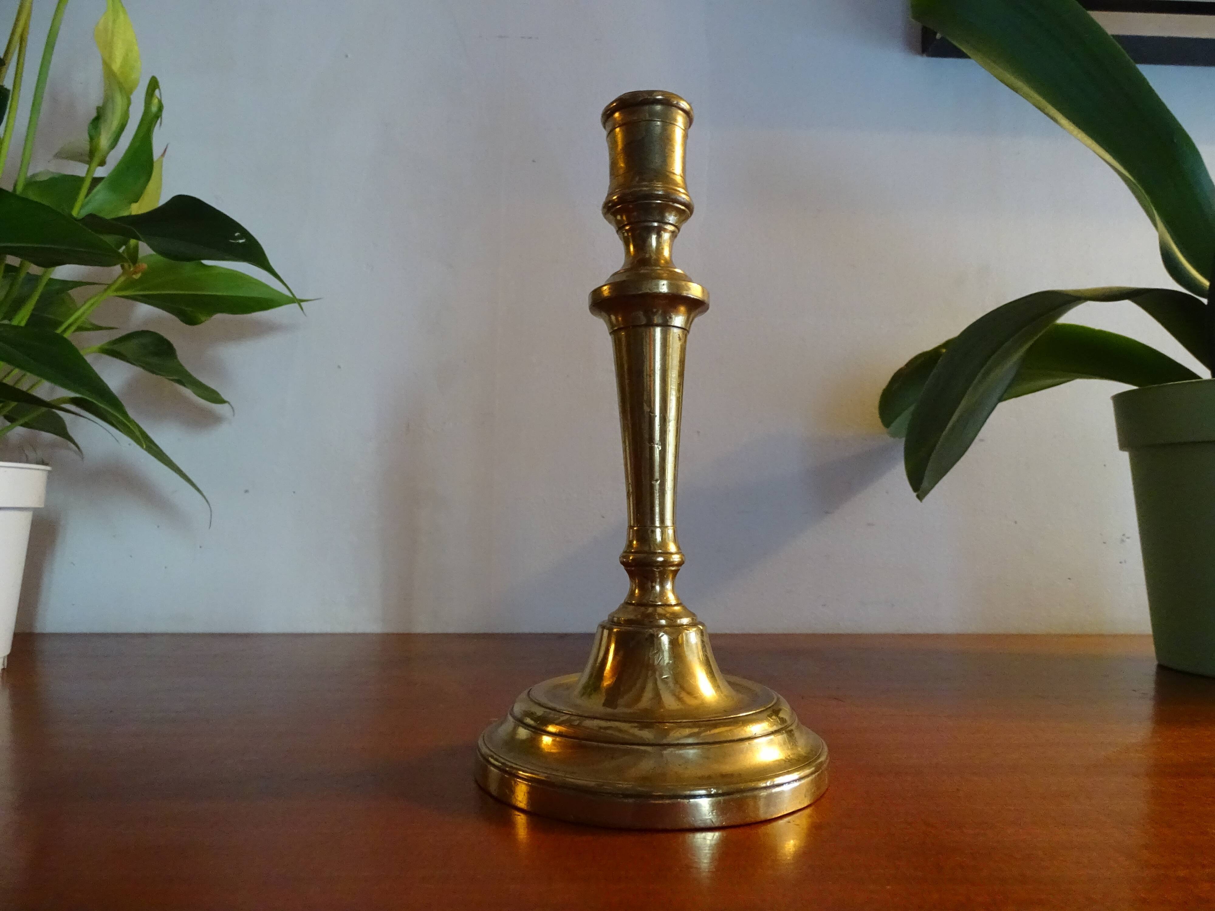 Old brass candle holder and its candle 21.5 cm