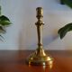 Old brass candle holder and its candle 21.5 cm