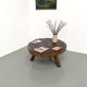 Brutalist coffee table in solid teak, monolithic slab, tripod base.