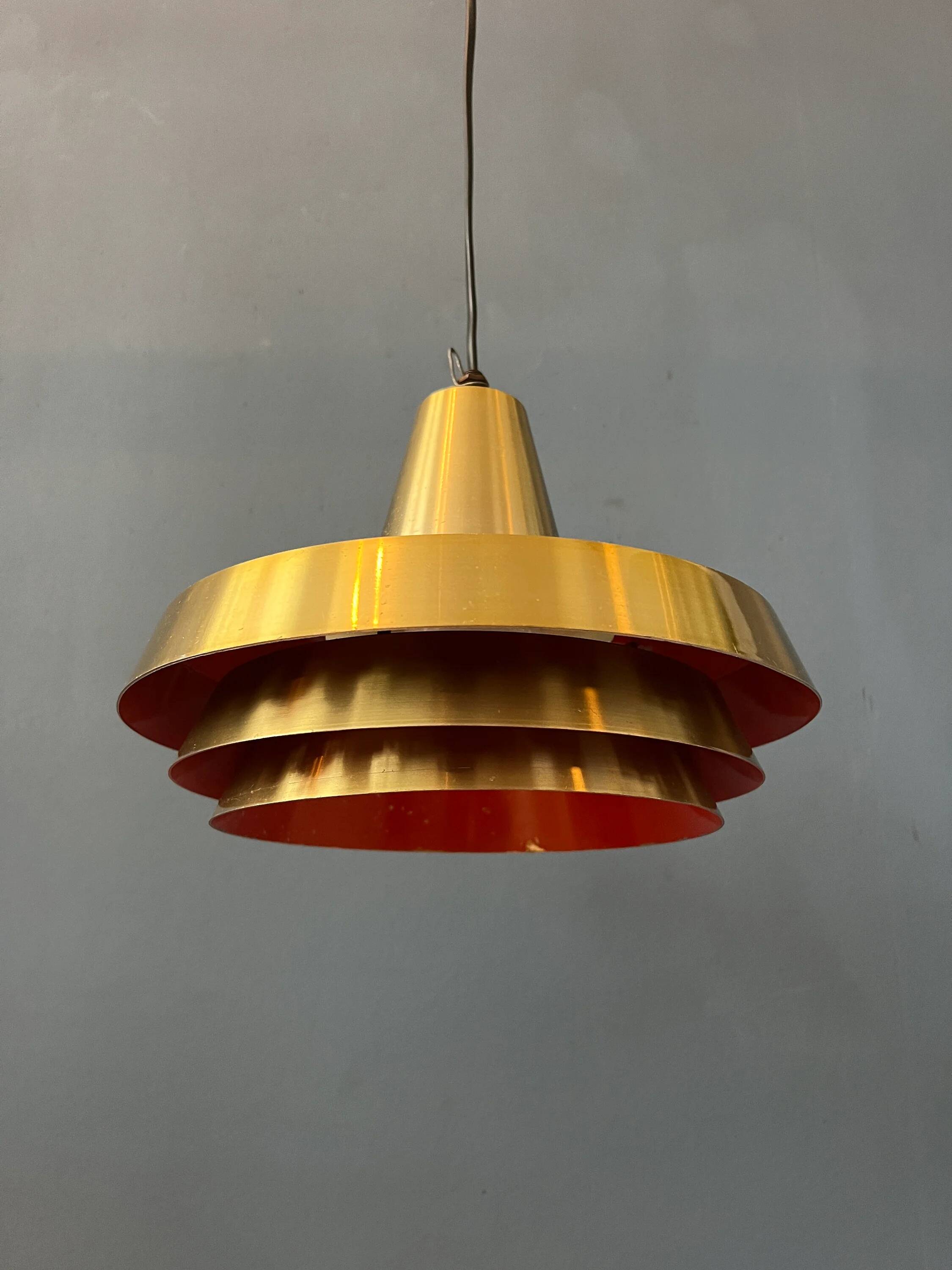 Mid-century Danish style orange brass suspension light.
