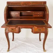Louis XV cylinder desk with floral marquetry and gilded ornaments.