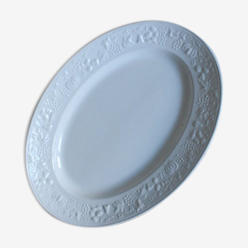 Old white serving dish in white earthenware