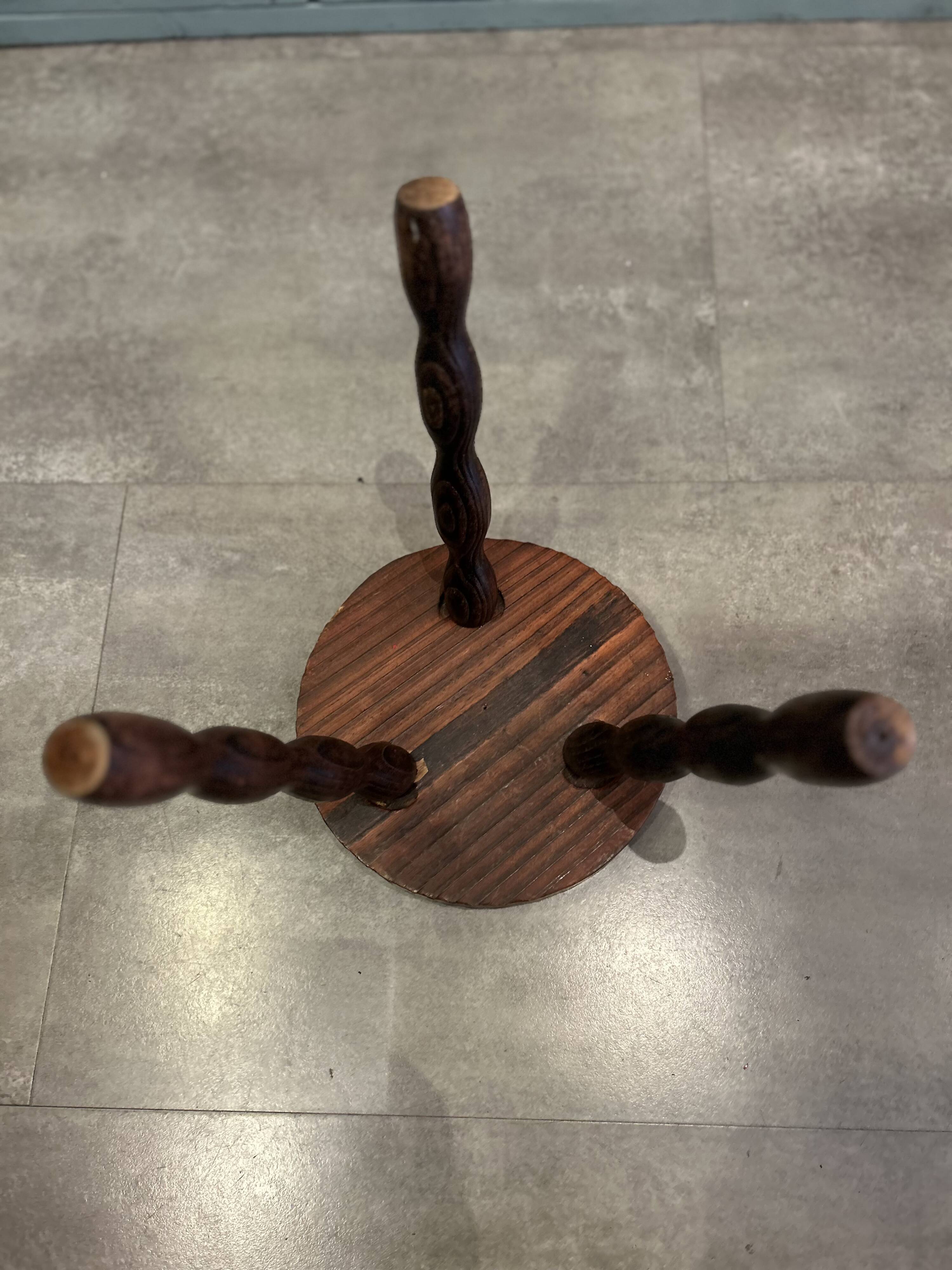 Three-legged stool with beaded wooden legs