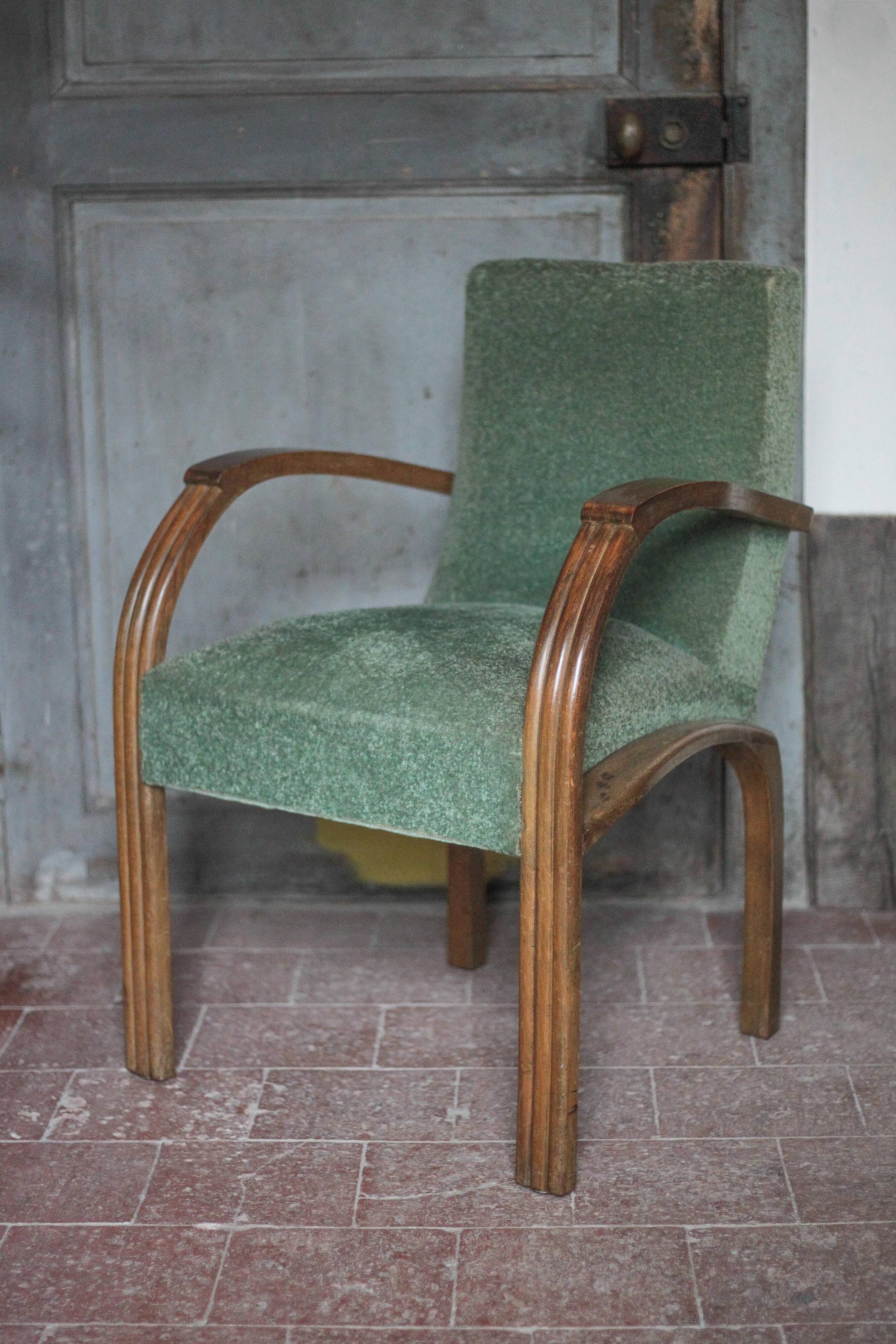 Art Deco armchair in wood and green fabric, living room armchair, interior decor.