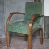 Art Deco armchair in wood and green fabric, living room armchair, interior decor.