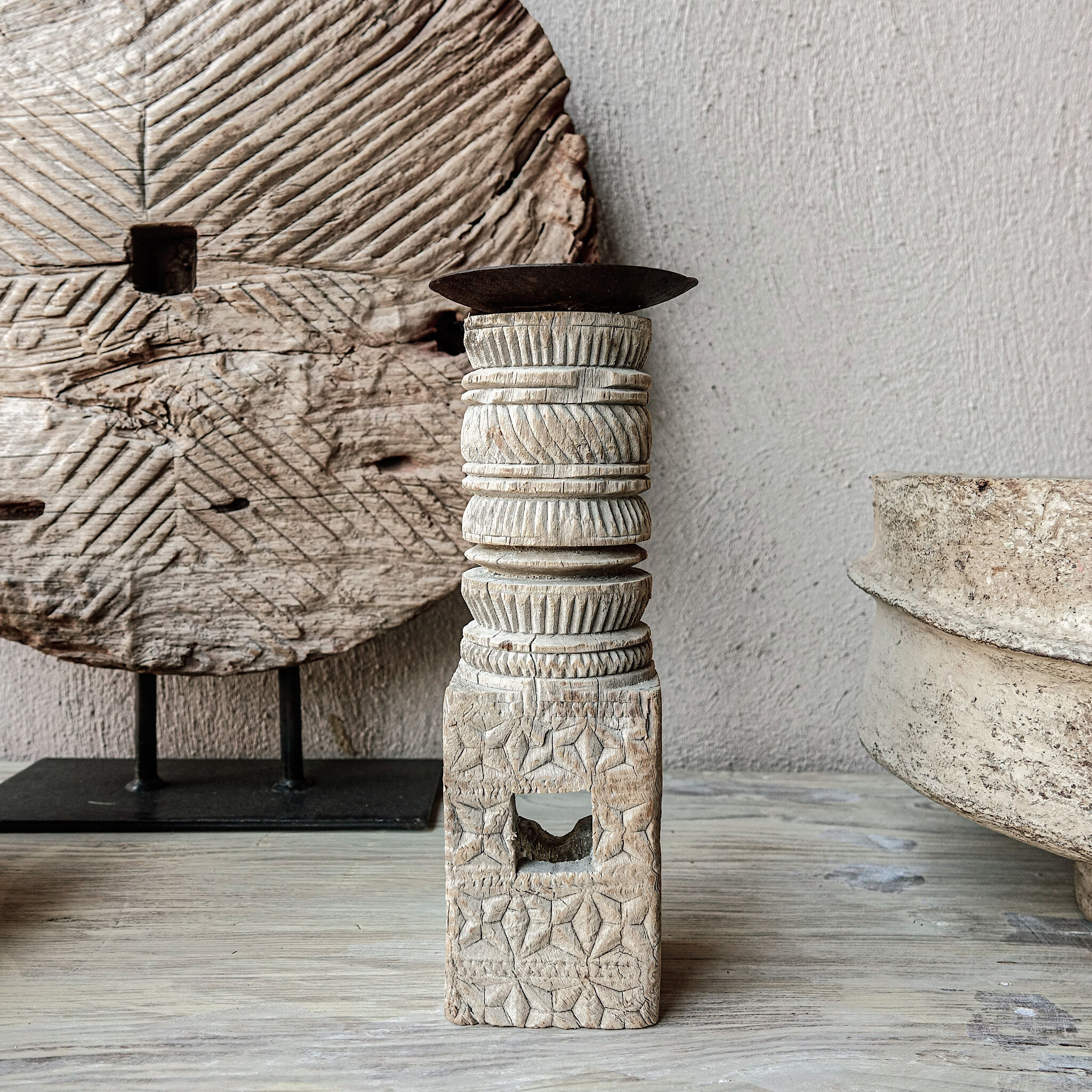 Candle holder in light carved wood