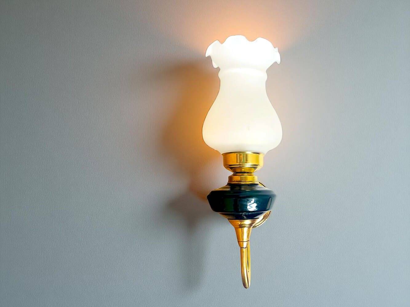 Brass wall sconce with frosted glass tulip lampshade