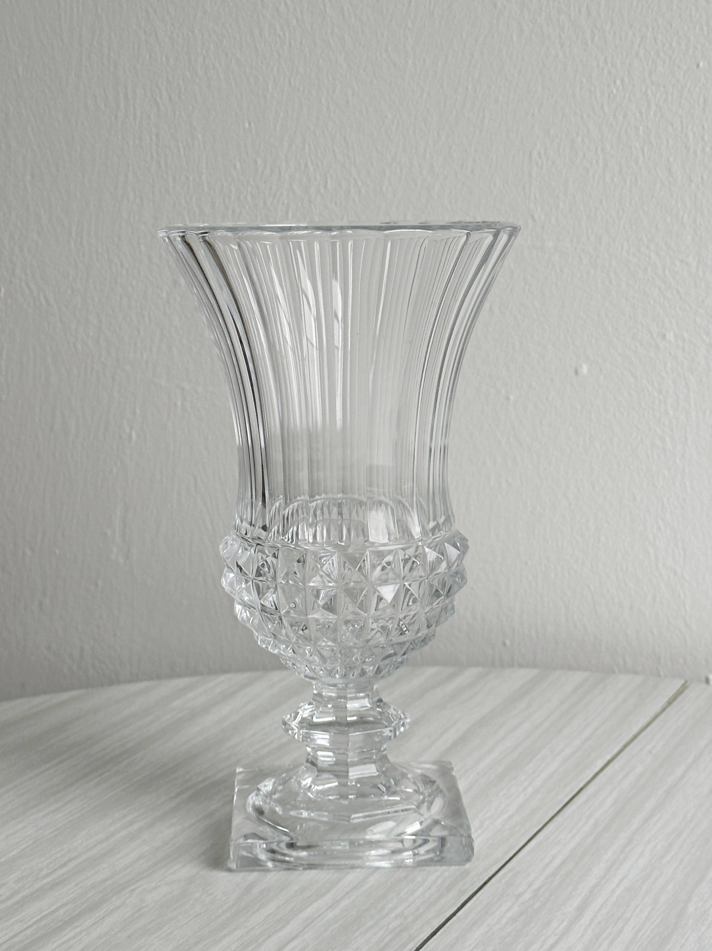 Antique thick glass vase on a pedestal.