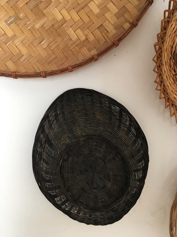 Wall composition of seven baskets and wicker trays