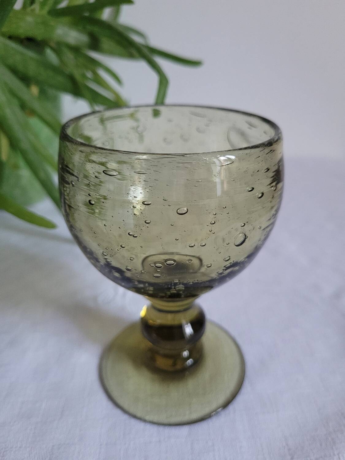 Footed glass made of blown glass