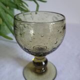 Footed glass made of blown glass