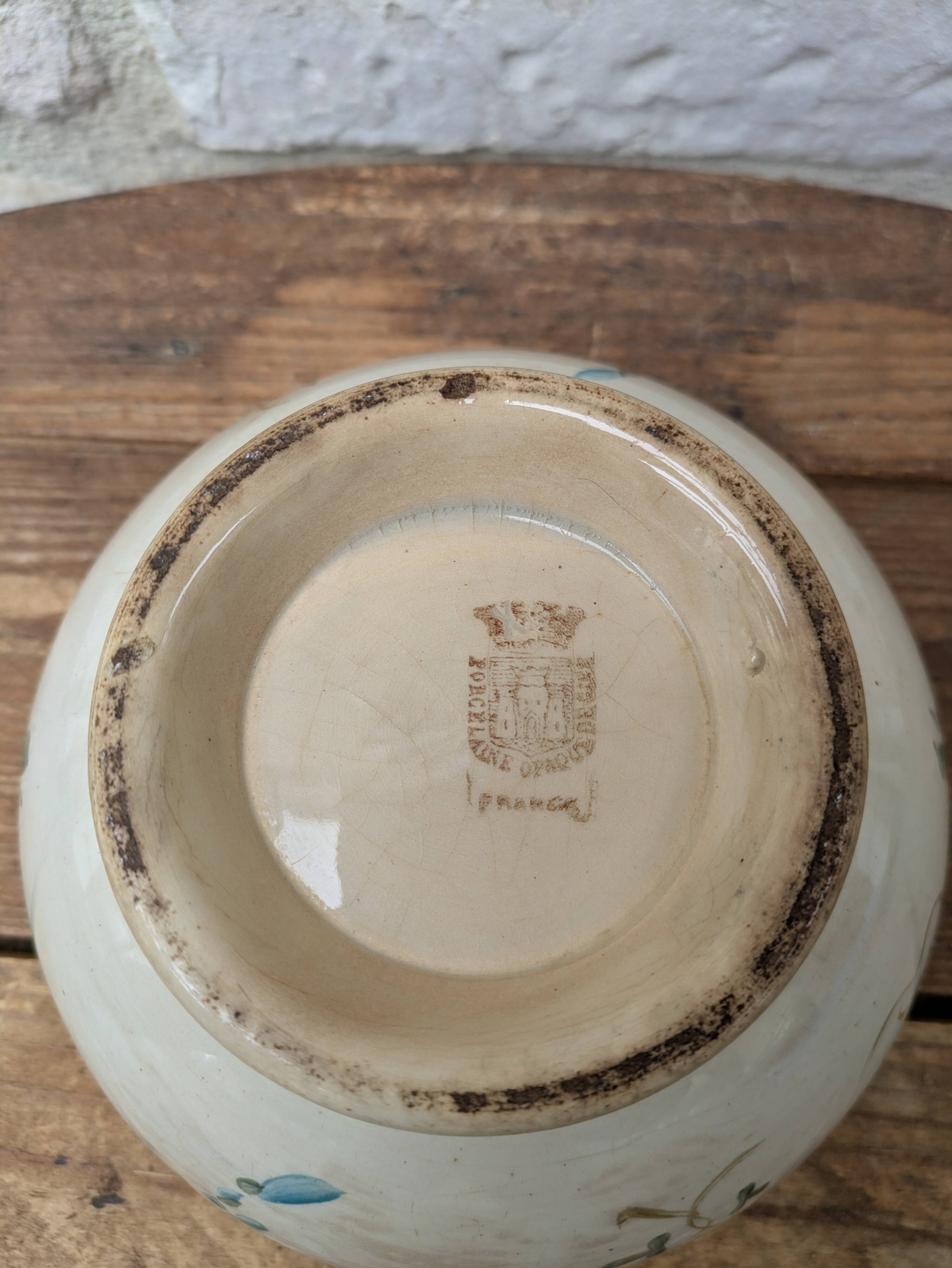 Old opaque porcelain bowl from Gien with a floral decoration.