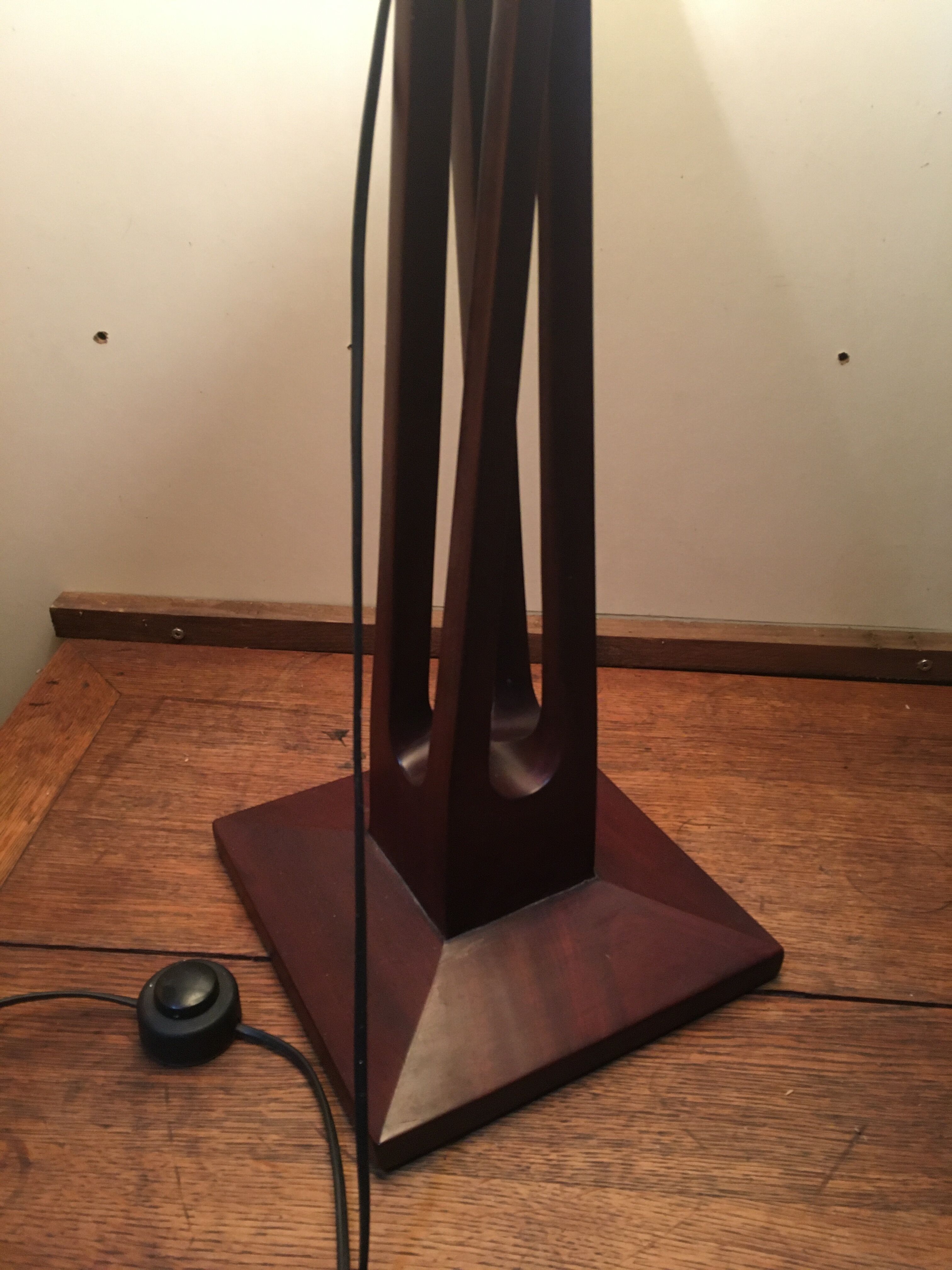 Mahogany lamp with a sculpted base.