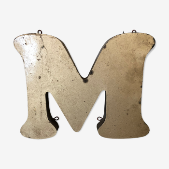 Golden sign letter "M"