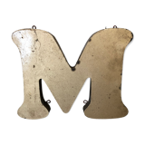 Golden sign letter "M"