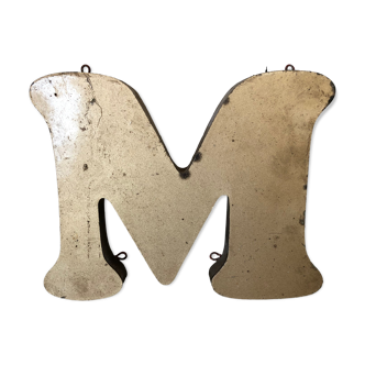 Golden sign letter "M"