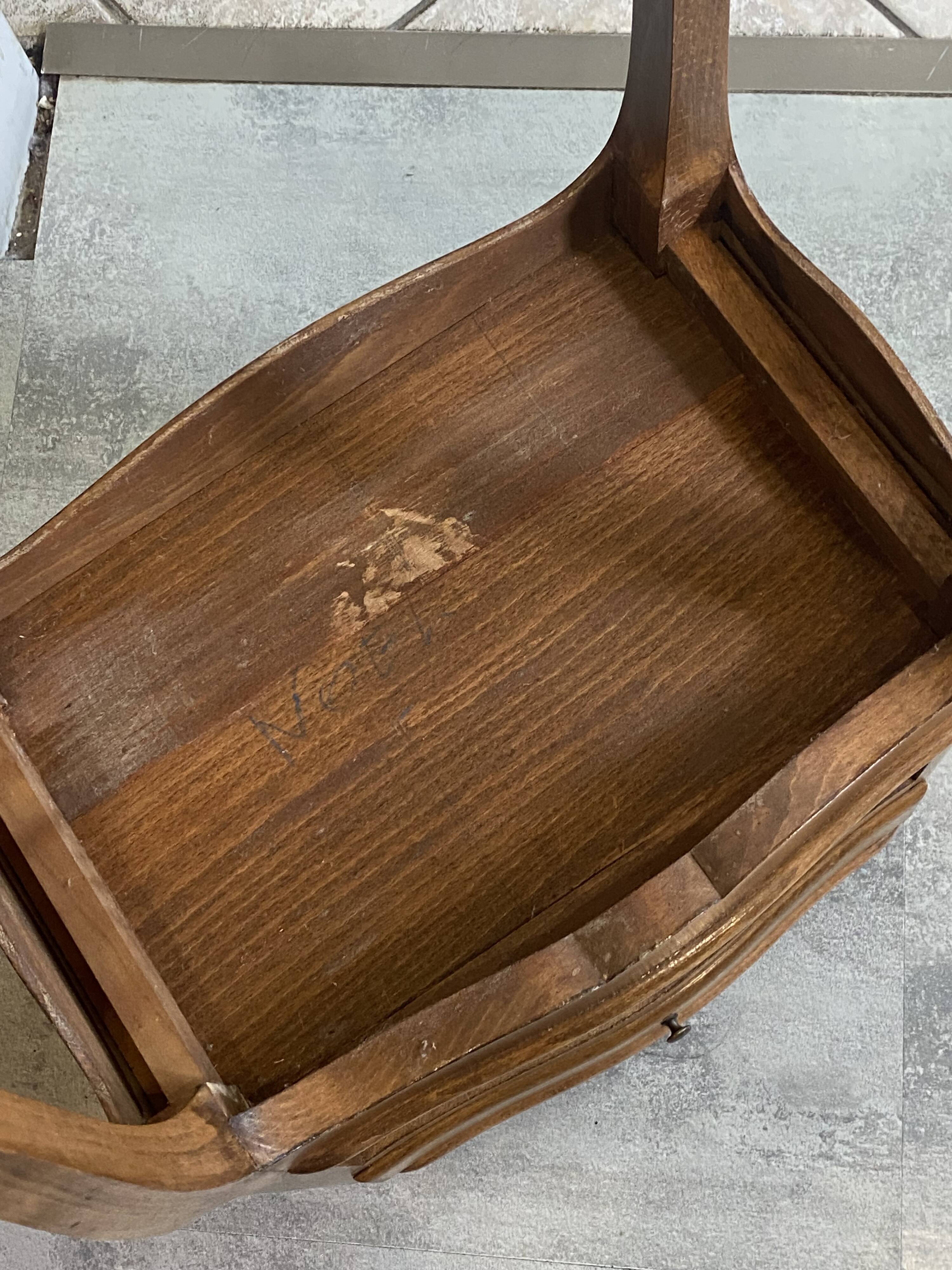 A bedside table with a drawer and a niche in Louis XV style.