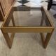 Modernist side table in wood and smoked glass