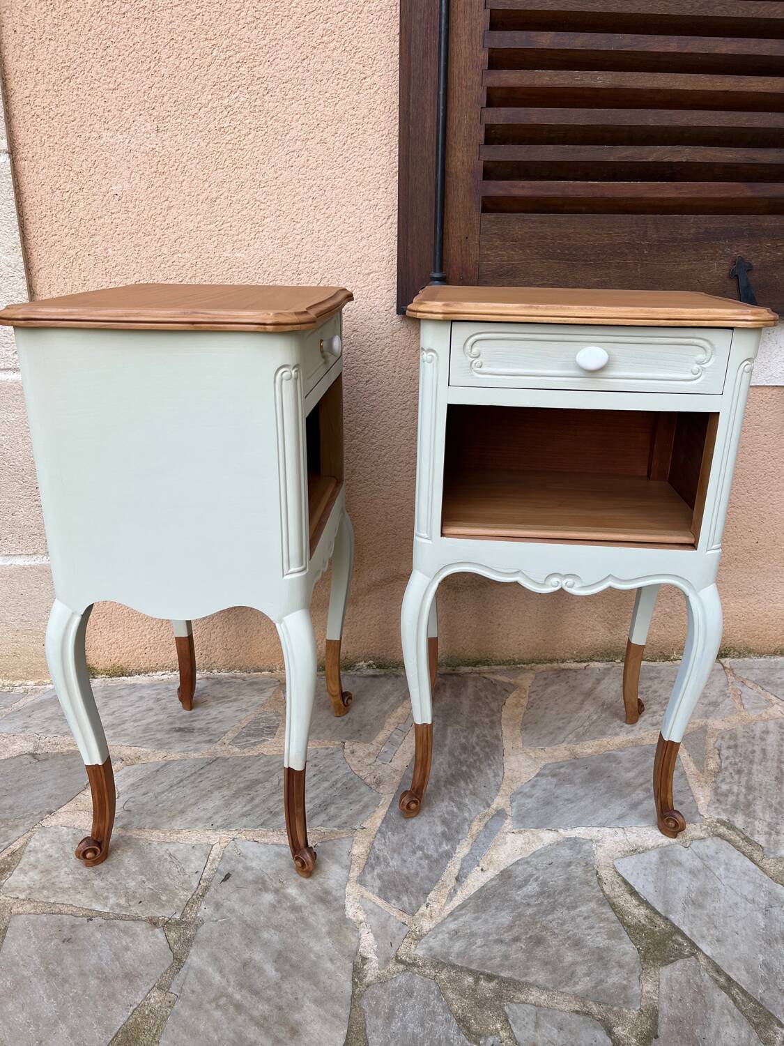 Renovated bedside tables in laurel green and light wood.