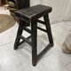 Rectangular stool in raw black elm.