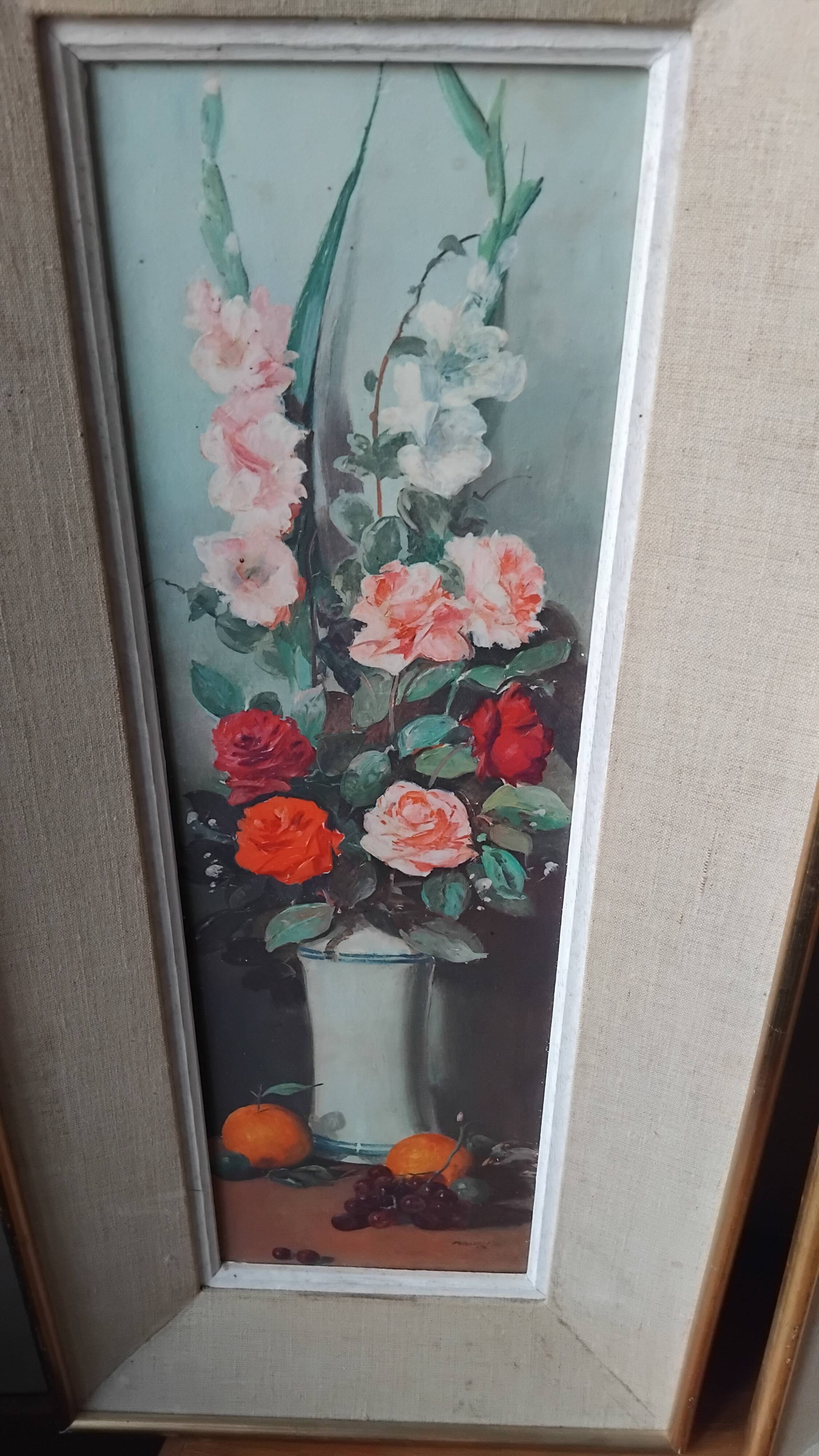 Pair of framed paintings featuring a composition of flowers.
