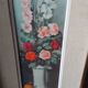 Pair of framed paintings featuring a composition of flowers.