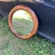 Round varnished wooden mirror