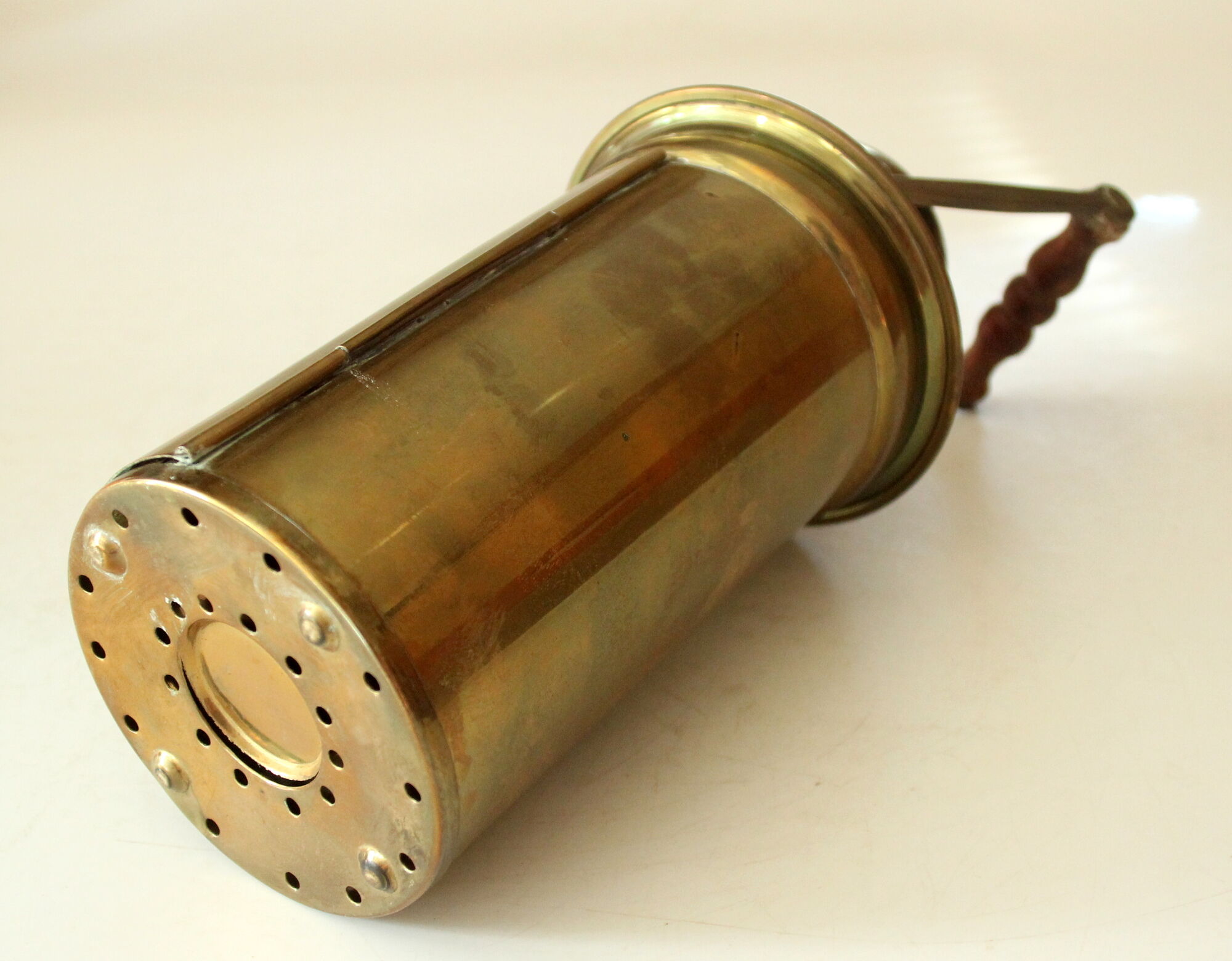 Decorative brass and glass oil lamp, wind light with wooden handle, vintage from the 1970s