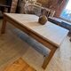 Large square antique coffee table made of raw solid wood.